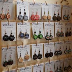 the earrings are hanging up on the wall for display in the shop or storefront