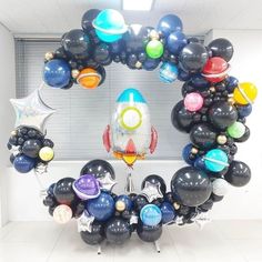 a bunch of balloons that are in the shape of a rocket ship