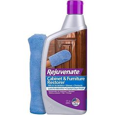 a bottle of cabinet and furniture cleaner next to a blue sponge