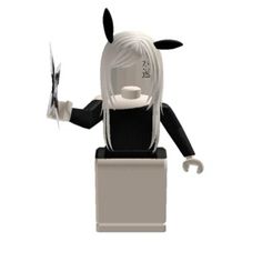 a black and white figurine holding a knife in one hand with both hands