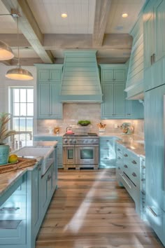 a kitchen with light blue cabinets and wood flooring is pictured in this image from the front view