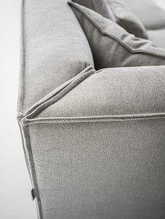 a close up view of the back end of a couch that is made out of fabric