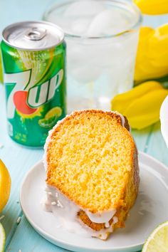 a piece of cake sitting on top of a white plate next to a can of soda