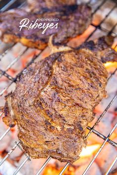 two steaks are cooking on the grill, with words above it that read prepared ribeyes