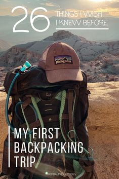 a backpack sitting on top of a mountain with the words 26 things i wish i knew before my first backpacking trip