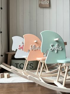 three wooden rocking chairs with names on them