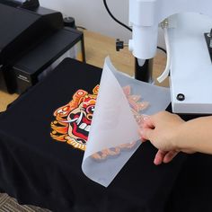 a person is using a machine to cut paper