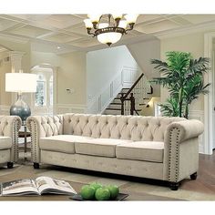 a living room filled with furniture and a chandelier