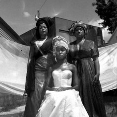 three women in dresses standing next to each other