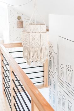 a chandelier hanging from the ceiling in a room with white walls and wood floors