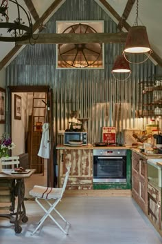 a kitchen with an oven, microwave and other items in the room that is old