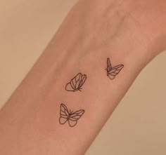 three small butterflies on the wrist