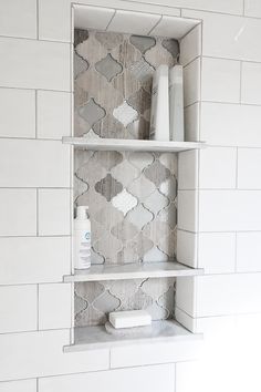 a white shelf with some items on top of it in a room that is tiled