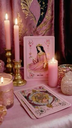 a table topped with cards and candles