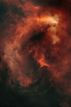 an orange and red cloud filled sky with dark clouds in the center, as if it were swirling