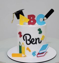 a white cake with letters and numbers on it that says abc, b & n