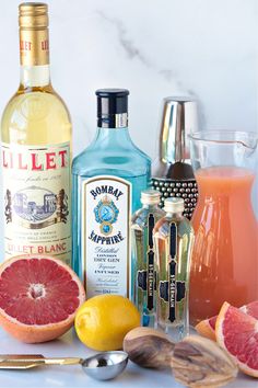 an assortment of alcoholic drinks including grapefruit, orange juice and gin