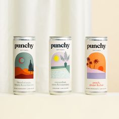 three cans of punchy are sitting on a white shelf in front of a curtain