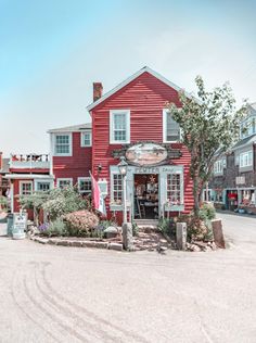 a red building with white trim and windows