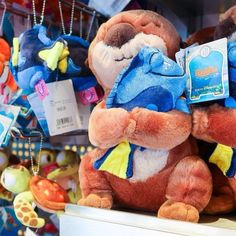 several stuffed animals are on display in a toy store with tags hanging from the ears