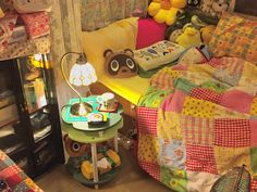 a room with stuffed animals and quilts on the walls, including a teddy bear