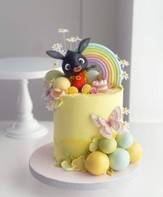 a cake decorated with an animal and rainbow decorations