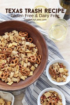 two bowls filled with cheesy cornflakes on top of a table next to wine glasses