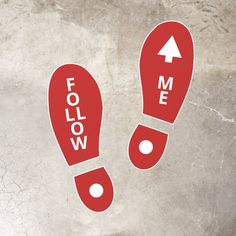 two red footprints with the words follow me and arrow pointing up to each other on a gray background