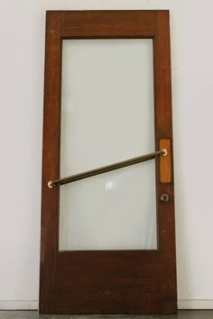 an old door with a glass window on the outside and brass handles to handle it