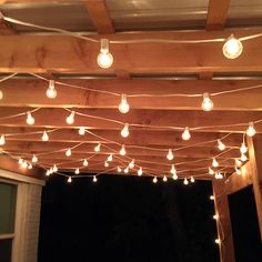 some lights are hanging from a wooden structure