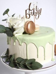 a cake decorated with white flowers and green icing