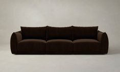 a brown couch sitting on top of a white floor