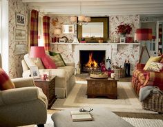 a living room filled with furniture and a fire place in the middle of the room