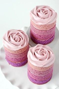 three cupcakes with pink frosting on them