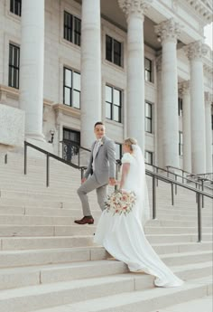 a bride and groom walking up the steps to their wedding ceremony at the state capitol building