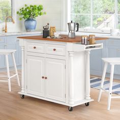 a kitchen island with two stools next to it