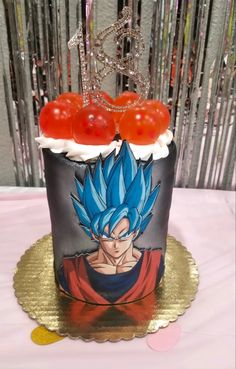 a dragon ball cake with cherry tomatoes on top and chains hanging from it's sides