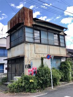 an old run down building on the corner of a street