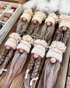 several long braids with hats on them are sitting on a table next to other items