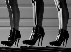 three women in high heels standing on top of each other