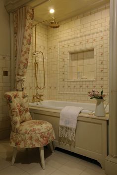 a bath room with a chair and a tub