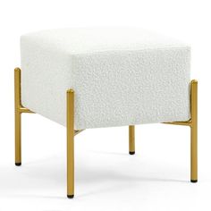 a white ottoman with gold legs and a square foot rest on the bottom half of it