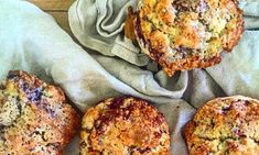 four muffins sitting on top of a red and white towel