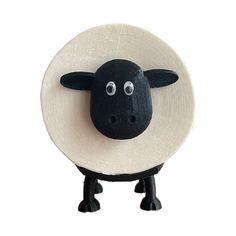 a black sheep with a white hat on it's head is standing in front of a white background