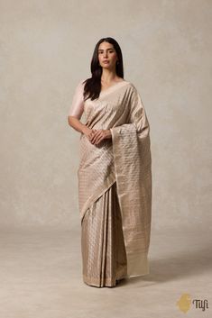 "\nA beautiful labyrinth of paisleys, a celebration of Indian textile arts. Influenced and inspired by a Kashmiri design legacy, a Banarasi Tanchoi Jamawar is an enchanting and distinctive handloom saree.\u00a0\n\n\n Color - A light shade of Beige\n\n Technique\u00a0- The\u00a0finest Tanchoi weaving technique, which employs one or more warps and multiple coloured wefts to produce a self-design which covers the body of the saree.\u00a0Tanchoi ensures that there is no float on the back of the saree.\u00a0\n\n Fabric\u00a0-\u00a0Soft as butter, Pure Soft Satin Silk\n\n Speciality - Banarasi weavers have sought inspiration in India's rich and varied regions and borrowed these elaborate paisley motifs from the Jamawar shawl and embroidery traditions of Kashmir. A beautiful handwoven piece of he Kashmiri Design, Paisley Motifs, India Inspired, Textile Arts, Indian Textiles, Shades Of Beige, Weaving Process, Self Design, Light Shade