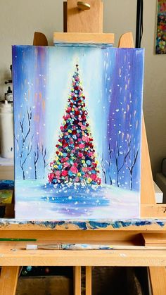 a painting of a christmas tree on an easel