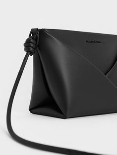 This product is made with at least 20% sustainable materials by weight. CHARLES & KEITH uses recycled, degradable, organic, and water-based materials in our eco-conscious collection. A little black crossbody bag offers a lot of style mileage, especially when it is as stylish as this iteration of the Midori bag. The elegant, minimal design features geometric folds and clean lines for a dynamic silhouette. Complemented by sculptural knots on the strap, the bag is understated yet visually interesting. Fitted with a zip closure that will keep your belongings secure, the Midori is a trusty carrier that will instantly elevate any outfit you pair it with. Black Crossbody Bag, Brand Collaboration, Size Chart For Kids, Charles Keith, Black Crossbody, Printables Kids, Black Cross Body Bag, Minimal Design, Belt Size