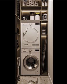 a washer and dryer in a small room next to a shelf filled with items