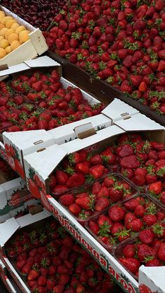 boxes of strawberries are stacked on top of each other