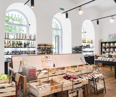 the inside of a store filled with lots of boxes and crates full of food on display